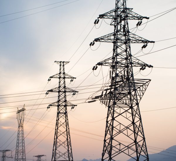 High voltage electricity pylon over sunset.